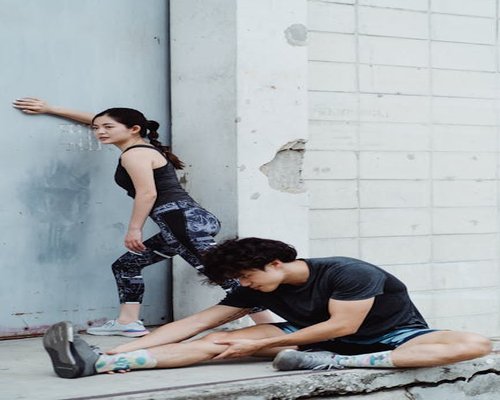 Adult performing light stretching exercises outdoors